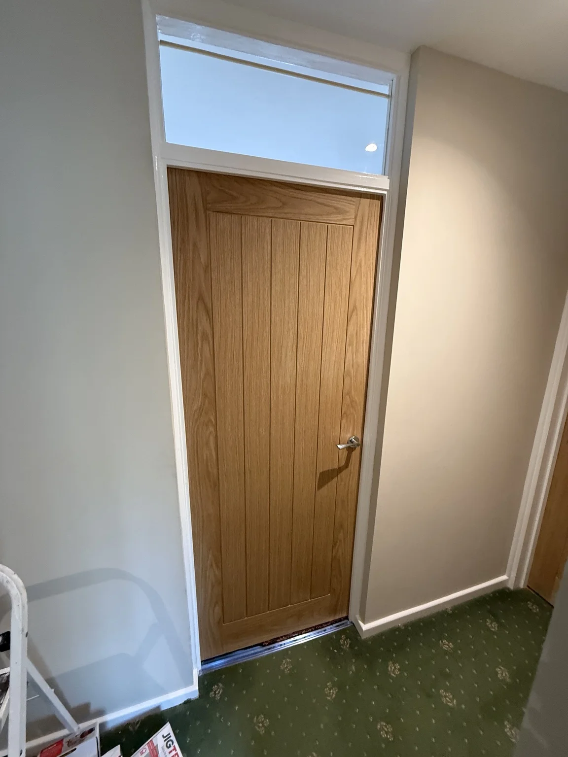Single fitted internal door and glazed over-door panel
