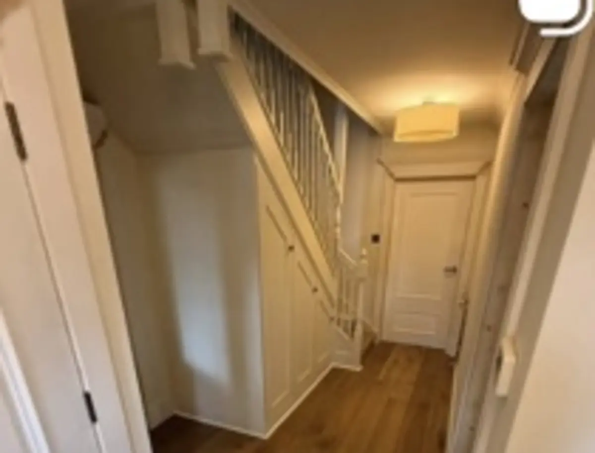Finished hallway carpentry with staircase, doors and timber flooring
